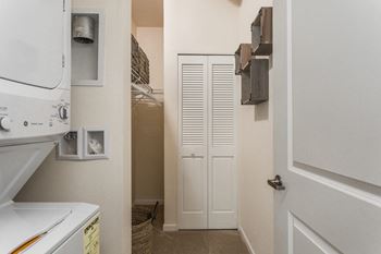 the laundry room has a washer and dryer and a door to the closet at 310 at Nulu Apartments-Student, Louisville Kentucky